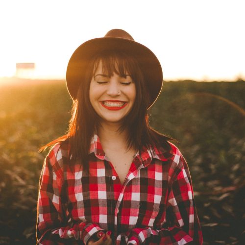 woman smiling with sunset in background